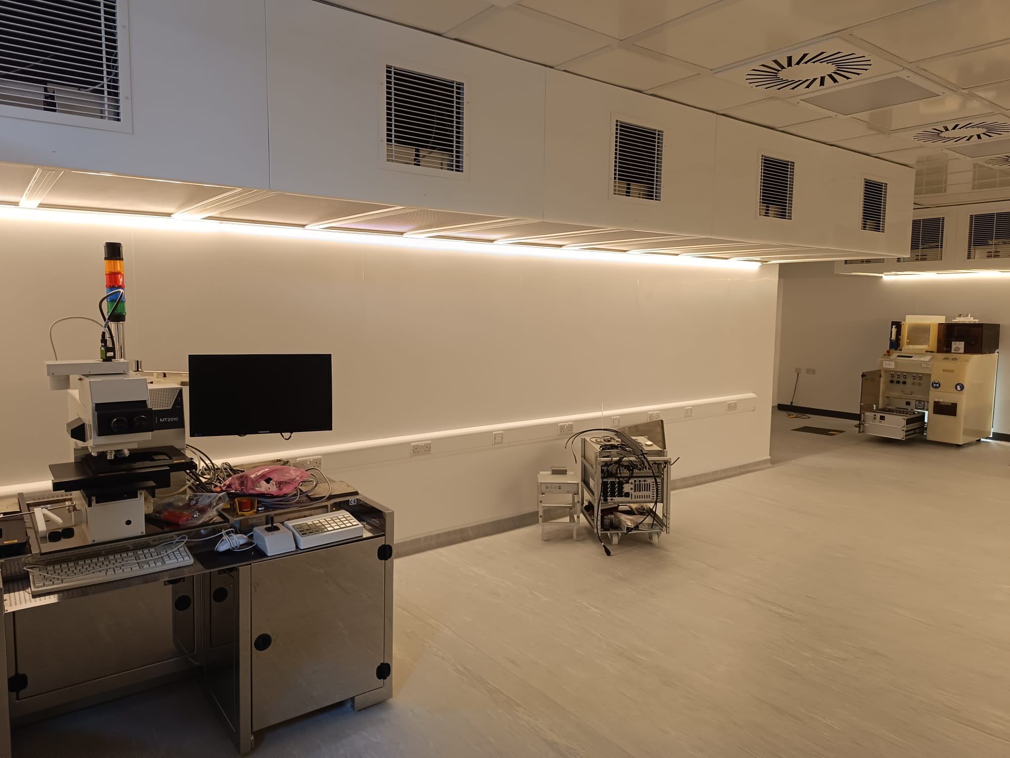 Cleanroom fit-out with LED panel lighting, ventilation grilles and a run of wall sockets