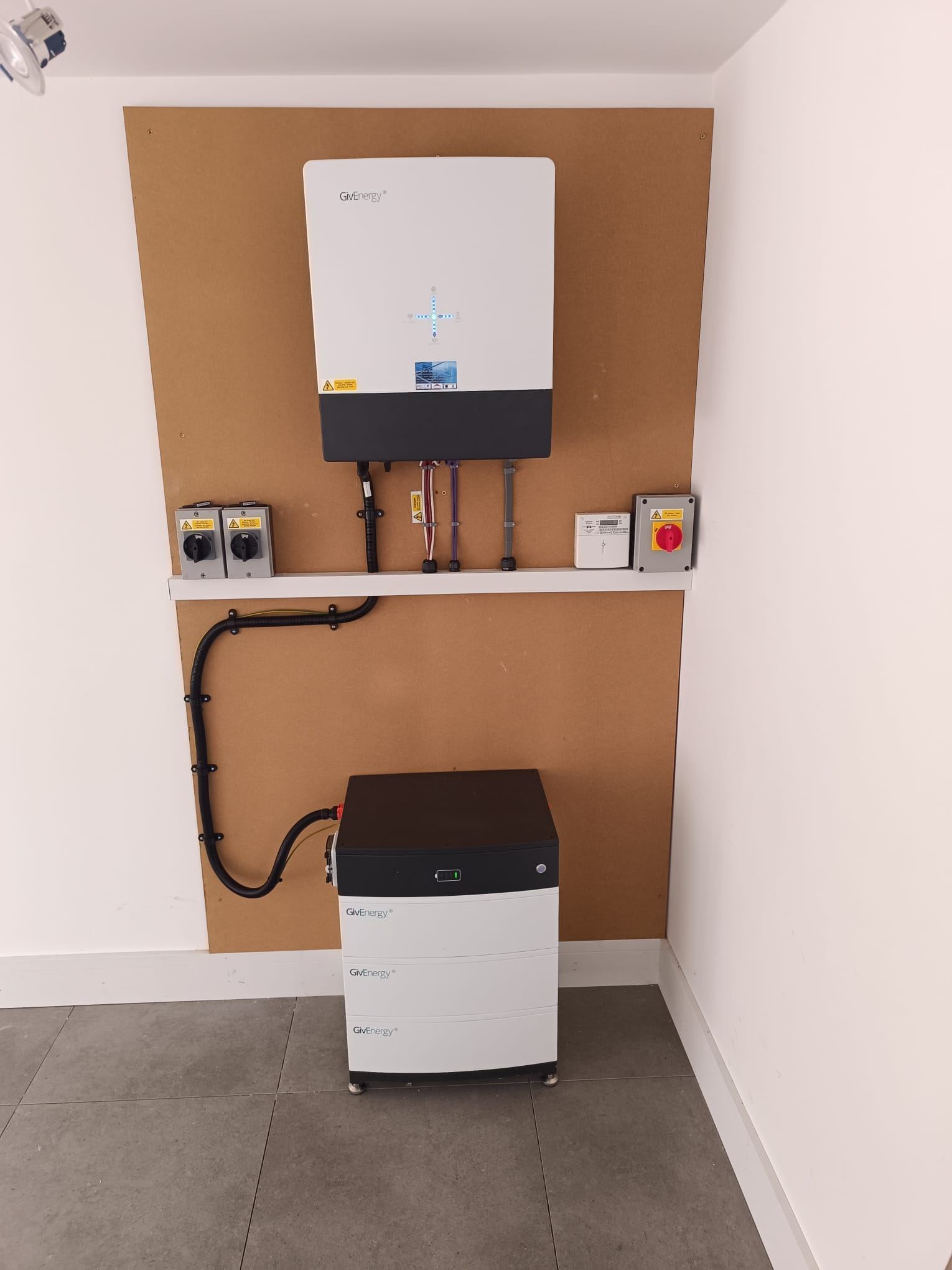 Hybrid inverter and stacked home battery installed in a utility room